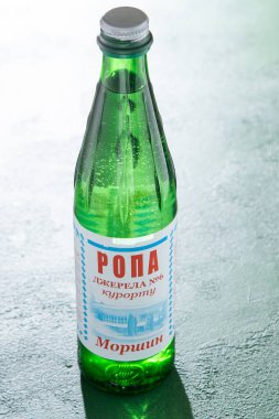 Glass bottle with Morshyn brine. Medicinal mineral water. Concentrate. Written in Ukrainian - medicinal product natural source. Ukraine, Morshyn - August 26, 2024 clipart