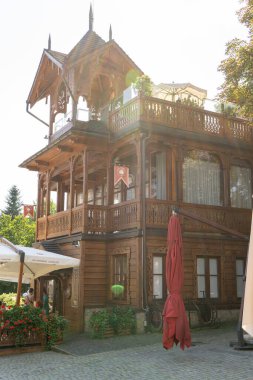 Wooden balcony of a wood house. Exterior facade windows. Old architecture eco home. Lviv chocolate workshop. Cafe. Ukraine, Truskavets - August 11, 2024 clipart