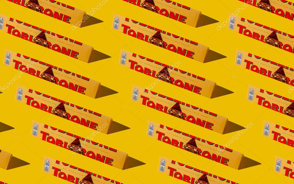 Toblerone brand chocolate packaging. Swiss Mondelez candy. Yellow pack background. Top view pattern set. Ukraine, Kyiv - November 4, 2024.