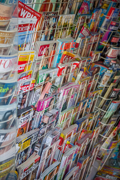 Magazine sales. Press shop store. Paper editions press news. Warsaw, Poland - June 29, 2019