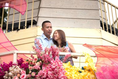 Portrait of a romantic Asian couple embracing each other in a beautiful park in autumn.Valentine's Day. Concept of love