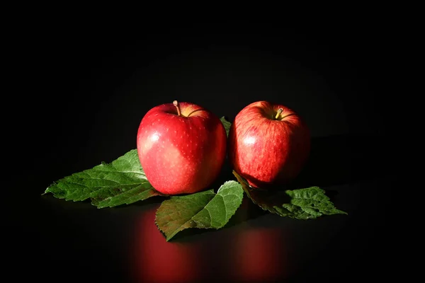 Close Red Apples Green Leaves Isolated Black Background Stok Foto Bebas Royalti