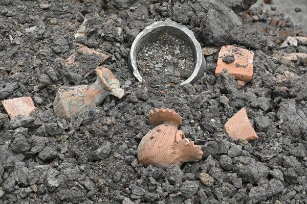 Close-up of old broken potteries on the ground