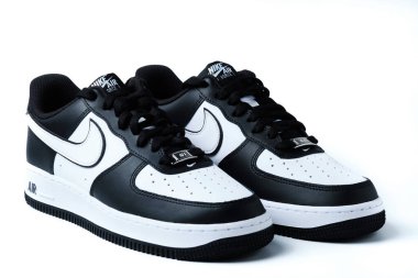 Pair of black and white Nike Air Force One Low sneakers isolated on white illustrative editorial