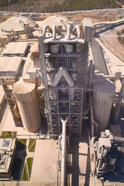 Towers of cement producing plant. Aerial view of huge industrial factory.