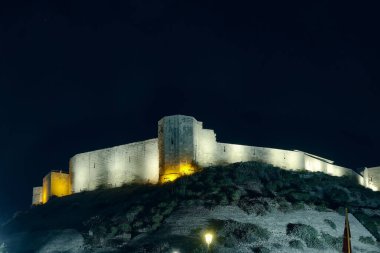Illuminated Gaziantep Castle walls against night sky. July 2022