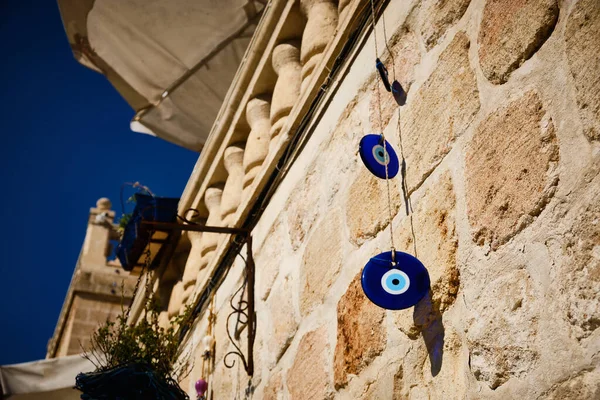 Hanging evil-eye amulets. Nazar is an eye-shaped amulet believed to protect against the evil eye