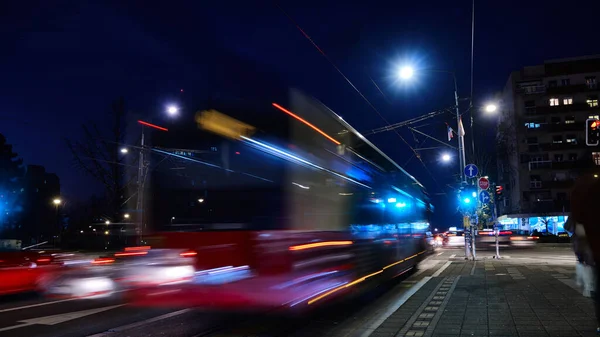 Long exposure shot of bus riding on city street. Traffic on evening city streets blurred motion defocused