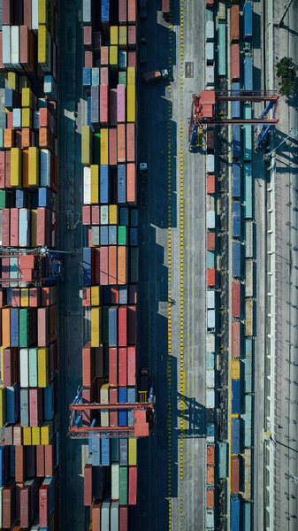Stacked cargo containers top down aerial view. Containers at logistics terminal. Cargo container outdoor warehouse