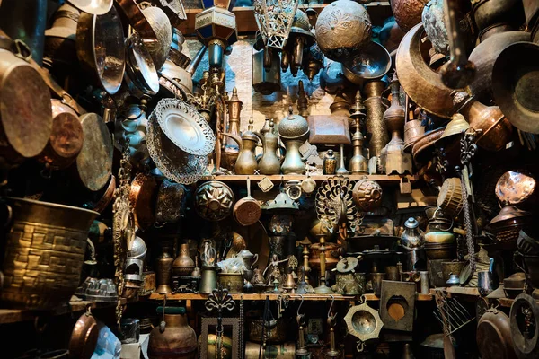 stock image Copper handicrafted jugs, plates and other tableware hanging in a traditional middle eastern market. Brass tableware shop