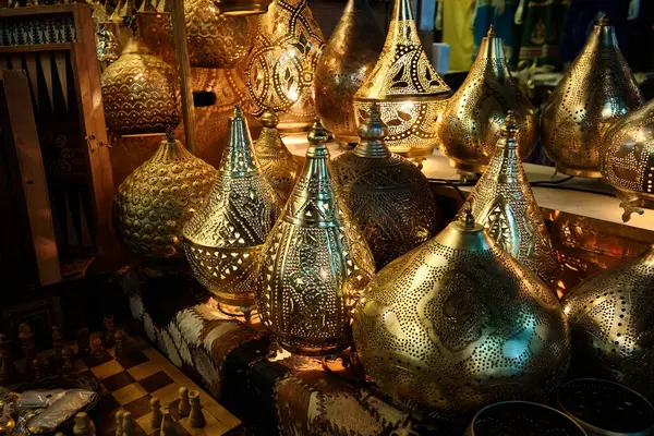 Glowing arabic lamps for sale in front of egyptian souvenir shop. Traditional middle eastern lanterns. Khan El Khalili market, Cairo, Egypt