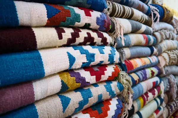 Orta doğu pazarında geleneksel renkli berber el dokuması yün halılar ve halılar. Geleneksel çarşıda geometrik desenli berber işçiliği