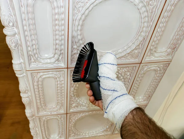 Male Hand Bandaged Hand Showing Holding Vacuum Brush Porcelain Stove — Stock Photo, Image