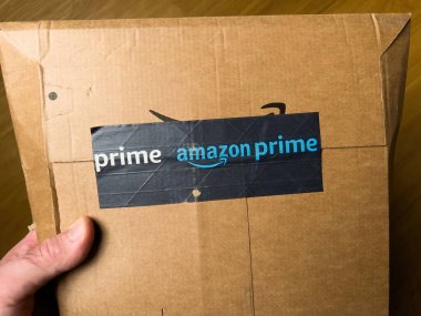 Paris, Fransa - 19 Şubat 2022: POV erkek, üzerinde Prime Amazon Prime logotype etiketi olan bir zarf paketini tutuyor