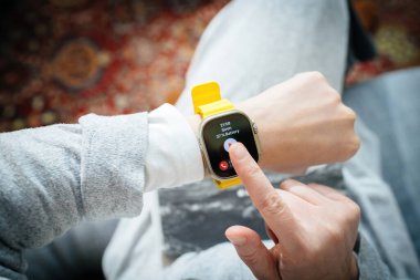 London, United Kingdom - Sep 28, 2022: POV woman hand pressing Siren emergency app -showing 38 percent battery new Apple Watch Series Ultra designed for extreme activities like endurance sports