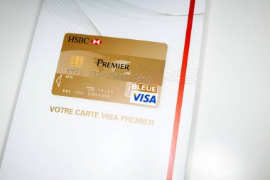 London, United Kingdom - Jan 14, 2015: HSBC Visa Premier luxury card white envelope with HSBC logotype on it - Hongkong and Shanghai Banking Corporation is a British multinational universal bank clipart