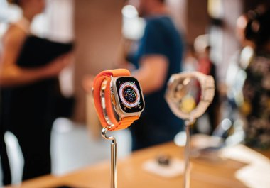 Paris, France - Oct 28, 2022: Hero object of Apple Watch ultra buy Apple Computers with customers in the background - hiking in orange strap