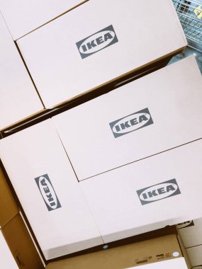 Paris, France - Oct 26, 2022: Ikea logotype insignia on multiple cardboard boxes inside furniture store