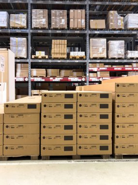 Paris, France - Oct 26, 2022: Front view - Vertical image of Ikea Kallax cardboard boxes with large warehouse in background