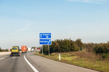 Austria - Sep 30, 2014: Driver POV at the Ungarn Hungary arrow sign direction on highway with right arrow to the Nickelsdorf, Neusiedl am See state of Burgenland