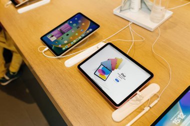 Paris, France - Oct 28, 2022: New iPad computer tablet recent versions on sale in Apple Store with Apple Pencil input device in special dedicated cradle