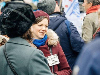 Strasbourg, France - 31 January 2023: Portrait of real smiling French woman at second demonstration against the new pension reform to be presented next month by French Prime Minister Elisabeth Borne