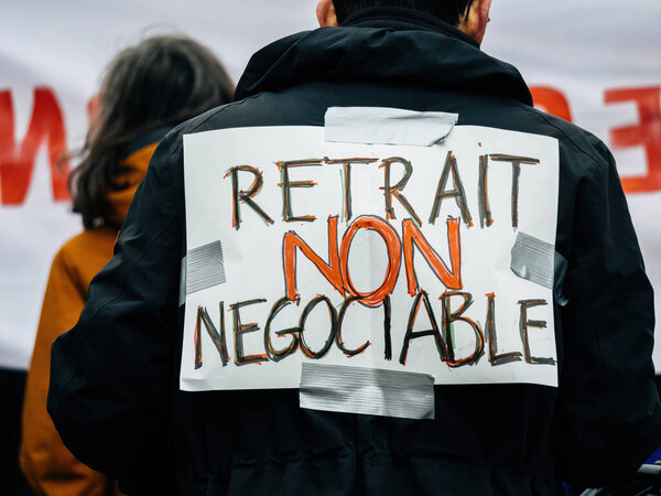 Strasbourg, France - 31 January 2023: retirement is not negociable palcard at second demonstration against the new pension reform to be presented next month by French Prime Minister Elisabeth Borne