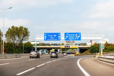 Austria - Sep 30, 2014: View from the highway at the blue direction signs above with Praha, Wien, Simmeringer haide, Bratislava, Budapest and Airport Flughafen A4 - driving in Austria near the border