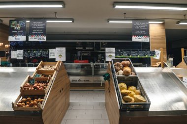 Strasbourg, France - Dec 19, 2022: Closed bio organic Alsatian supermarket with empty vegetables and fruit shelves - no customers inside