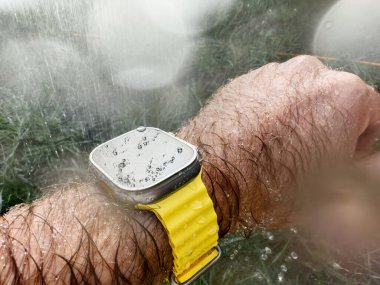 Paris, France - Sep 23, 2022: Male hand underwater diving swimming with new titanium Apple Watch Ultra designed for extreme activities like endurance sports water drops on the oled display