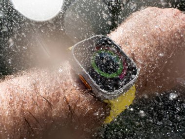 Paris, France - Sep 23, 2022: Closed all activity circles - Underwater diving Male hand swimming with new titanium Apple Watch Ultra designed for extreme activities like endurance sports water drops