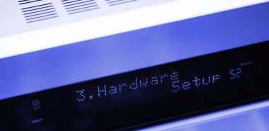Hardware setup text on the LCD display aluminum facade figh-end stereo audio hi-fi receiver - close-up tilt-shift lens used