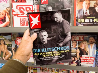 Frankfurt, Germany - Sep 3, 2022: POV male hand buying latest newspaper magazine die stern with portraits article feature about Wladimir and Vitali Klitschko brothers