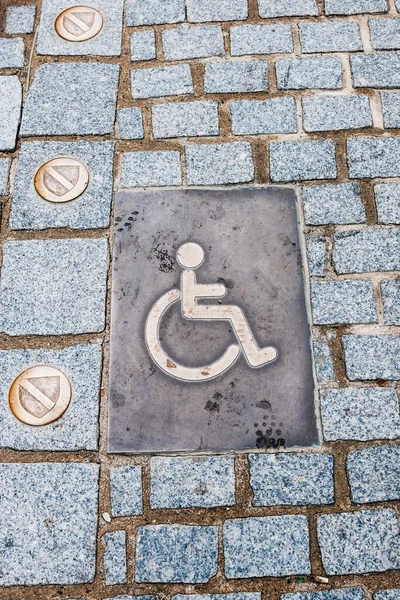 A bustling city with a modern transportation system, complete with disabled access and ample parking. The urban landscape features patterned flooring and walls accented by bright signs.
