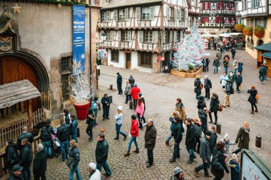 Colmar, 23 Kasım 2014: Colmar, Fransa 'da canlı bir grup Marche de Noel bayramını keşfeder. Renkli mimari ve şehir hayatı onları serin bir kış tatilinde sarar..