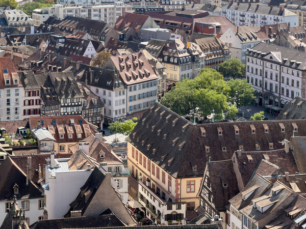 A stunning aerial view of Strasbourg, France reveals traditional timbered homes and bustling urban area with a unique architecture - French real estate postcard