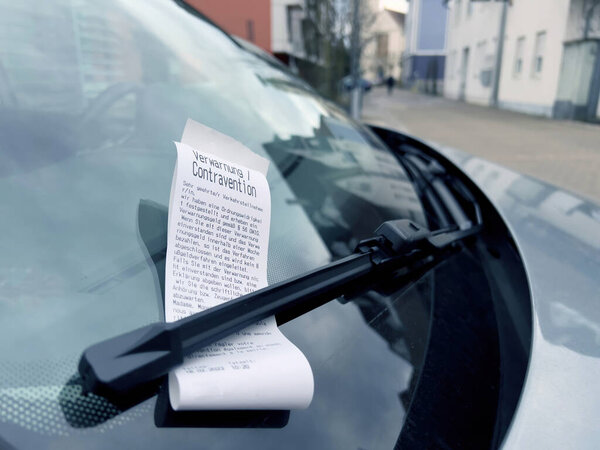 Kehl, Germany - Feb 18, 2023: Verwarnung, Contravention Fine paper on the windshield of a parked illegally car in germany