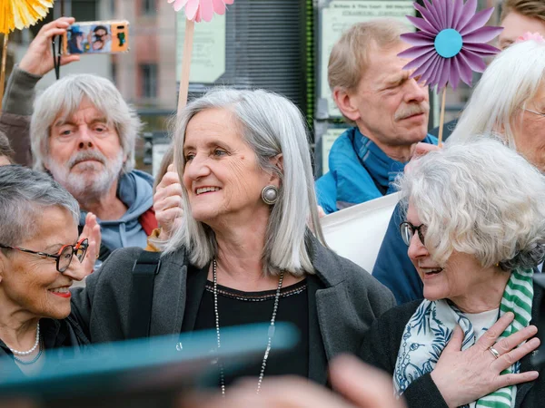 stock image Strasbourg, France - Mar 29, 2023: A group of determined Swiss seniors happy after decision of the court - protest in front of the European Court for Human Rights, demand action on climate change from