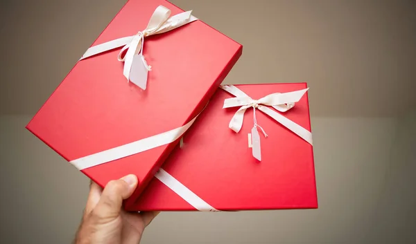 Masculine Hand Grasps Two Red Striking Crimson Gifts Meticulously Enveloped — Stock Photo, Image