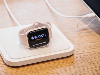 Paris, France - Sep 22, 2023: Currently charging, the Apple Watch Ultra 2 by Apple Computers touts an unparalleled chip upgrade, a screen brighter than its predecessor, and more expansive storage clipart