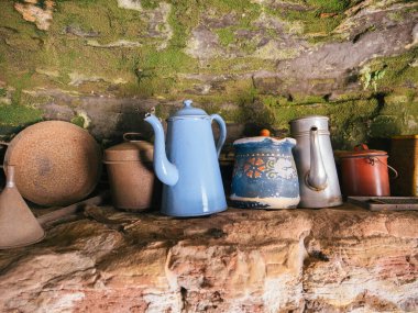Eski troglodit konutunun kırsal mutfağında, eski çömlek parçaları koleksiyonu karakter ve tarihi cazibe ekler.