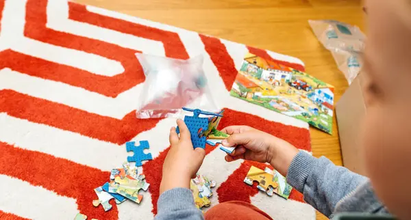 Pov Perspective Young Boy Meticulously Pieces Together Puzzle Seated Neatly — Stock Photo, Image