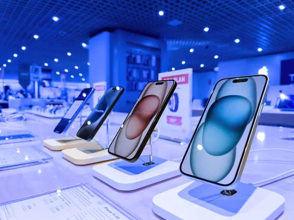 Stock image Strasbourg, France - Oct 1, 2023: A hero object view showcasing a row of the latest iPhone 15 Pro smartphones prominently, with the vast interior of the FNAC store forming the backdrop