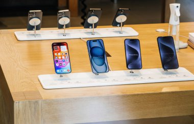 Paris, Fransa - 22 Eylül 2023: Bir dizi yeni Apple bilgisayarı ve tüm iPhone 15 Pro serisi, beklenen fırlatma günü boyunca Apple Bilgisayar mağazasındaki ahşap bir masada sergilendi.