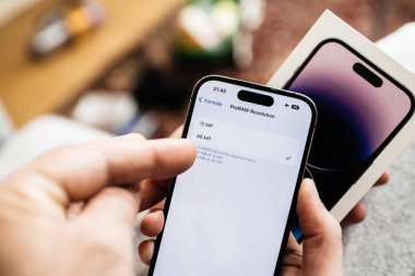 Londra, Birleşik Krallık - Sep 28, 2022: Bir kadın eli, en son iPhone 15 Pro 'da 12 milletvekili ve 48 milletvekili arasında seçim yapmak için kamera ayarlarında gezinirken yakalandı