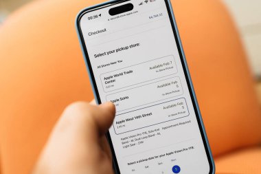 Kaliforniya, ABD - 21 Ocak 2024: iPhone kullanan bir erkek el, Apple World Trade Center, Apple SoHo veya Apple West 12. Cadde 'deki Vision Pro kulaklığı için tavlama seçenekleri seçer