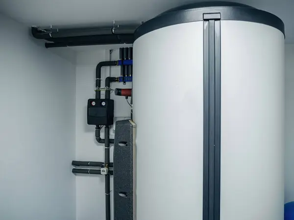 A contemporary heating system with a high-efficiency water tank, integrated into a clean and organized utility room