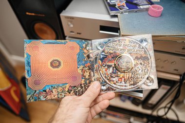 Paris, France - Jan 12, 2024: A male hand delicately holds the DSD Direct Stream Digital and SACD from ABKCO label, featuring the iconic album Their Satanic Majesties Request showcasing the high clipart