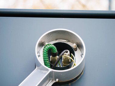 Tren istasyonu ekipmanlarının teknik bileşenlerini gösteren, bir demiryolu sinyal direğinin içerisindeki yeşil lambaların yakın plan görüntüsü..