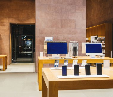 Paris, France - Dec 23, 2024: An empty Apple Store displays Mac Pro workstations with XDR Cinema Displays, iMacs, and iPhones, highlighting Apples cutting-edge technology clipart